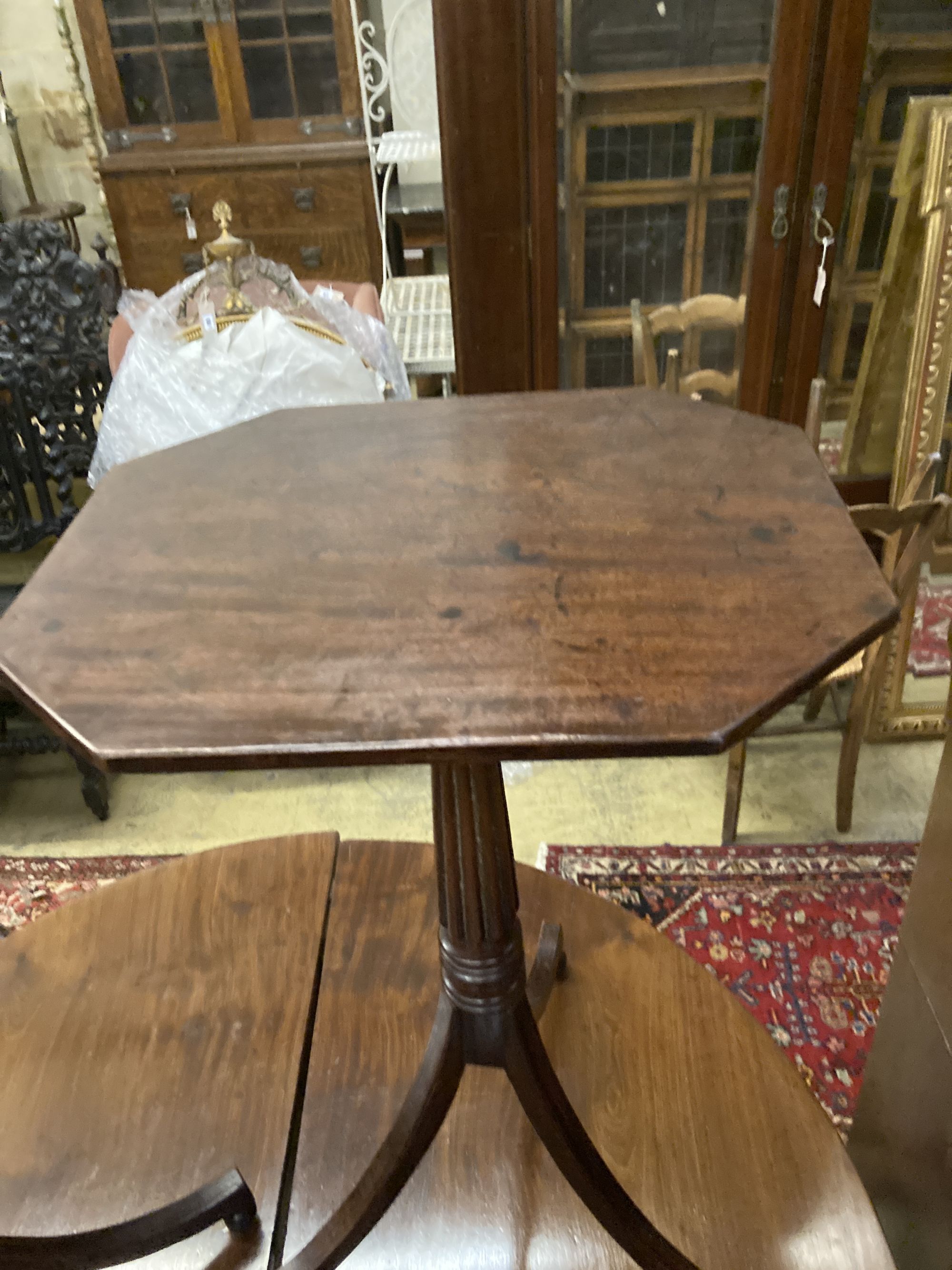 A pair of Regency style octagonal mahogany tripod wine tables, width 44cm depth 38cm height 72cm